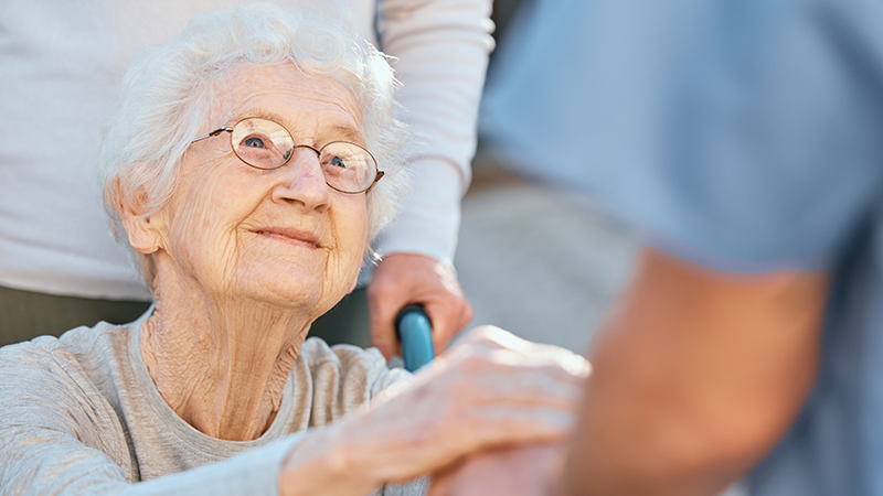 senior woman holding nurses hand