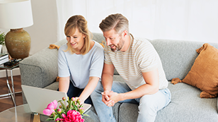 a couple looking at their laptop