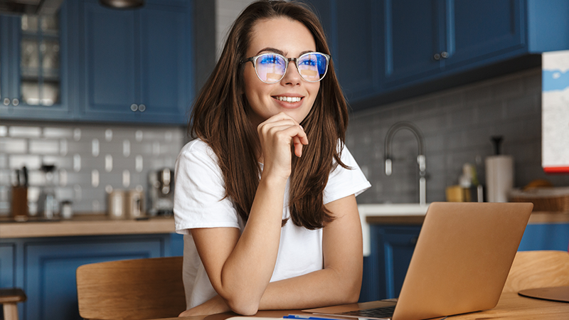 woman in her kitchen on her laptop